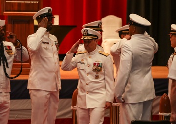 Rear Adm. Chris Cavanaugh salutes side boys during the Commander, Submarine Group 7 change of command ceremony