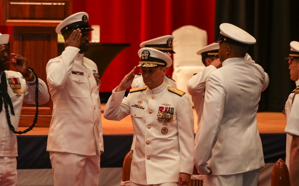 Rear Adm. Chris Cavanaugh salutes side boys during the Commander, Submarine Group 7 change of command ceremony
