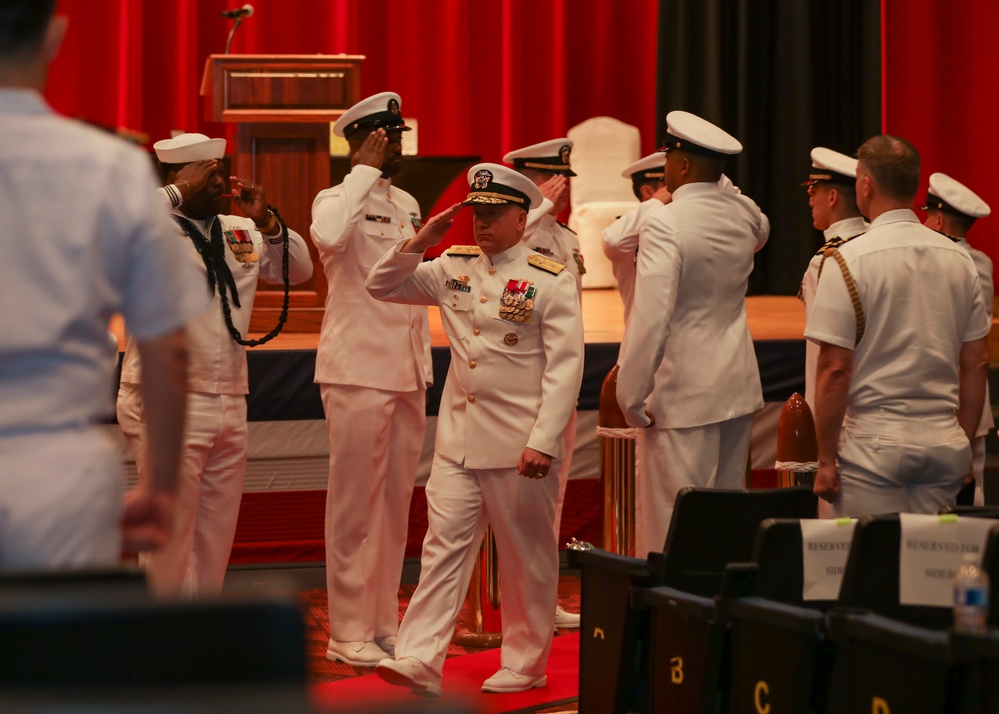 Rear Adm. Rick Seif salutes side boys during the Commander, Submarine Group 7 change of command ceremony.