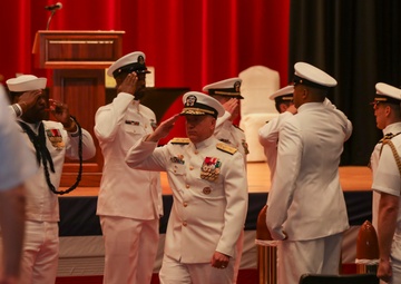 Rear Adm. Rick Seif salutes side boys during the Commander, Submarine Group 7 change of command ceremony.