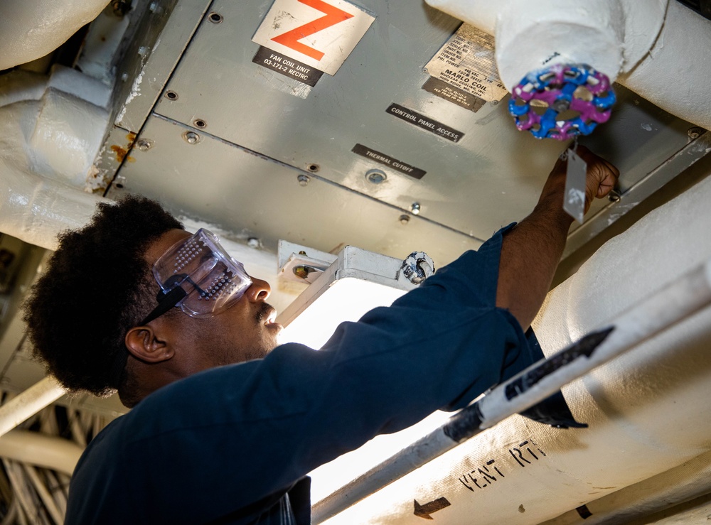 USS Robert Smalls (CG 62) Sailor Conducts Maintenance