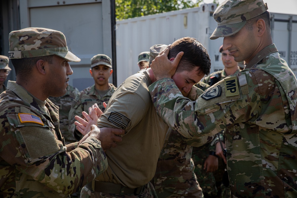 Soldiers from the 508th Military Police Company demonstrate detaining procedures to Albanian and Bulgarian servicemen during DEFENDER 23