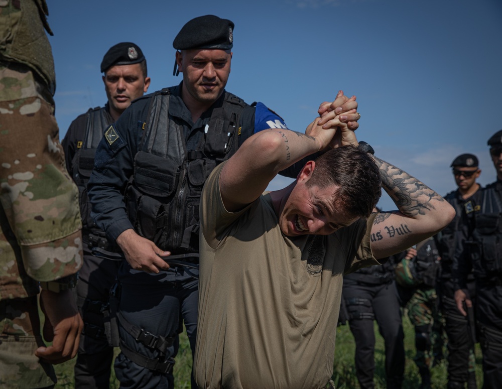 Soldiers from the 508th Military Police Company demonstrate detaining procedures to Albanian and Bulgarian servicemen during DEFENDER 23