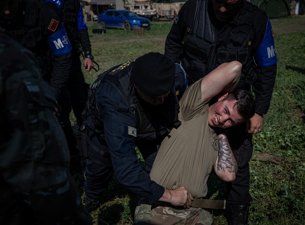 Soldiers from the 508th Military Police Company demonstrate detaining procedures to Albanian and Bulgarian servicemen during DEFENDER 23