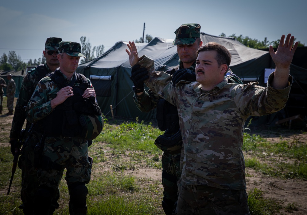 Soldiers from the 508th Military Police Company demonstrate detaining procedures to Albanian and Bulgarian servicemen during DEFENDER 23