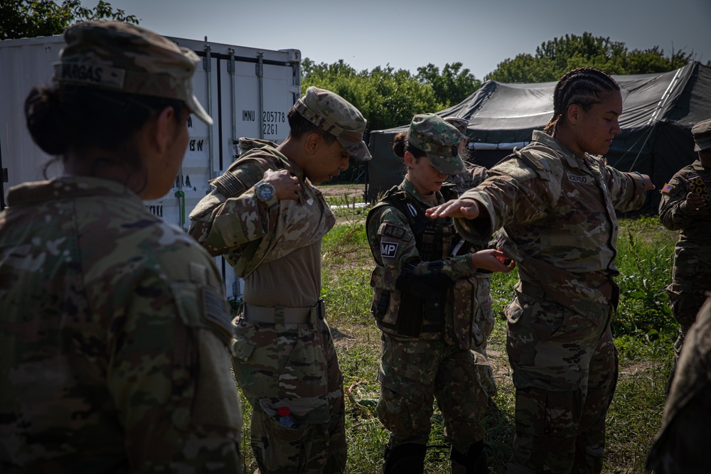 Soldiers from the 508th Military Police Company demonstrate detaining procedures to Albanian and Bulgarian servicemen during DEFENDER 23