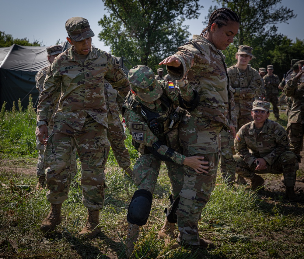 Soldiers from the 508th Military Police Company demonstrate detaining procedures to Albanian and Bulgarian servicemen during DEFENDER 23