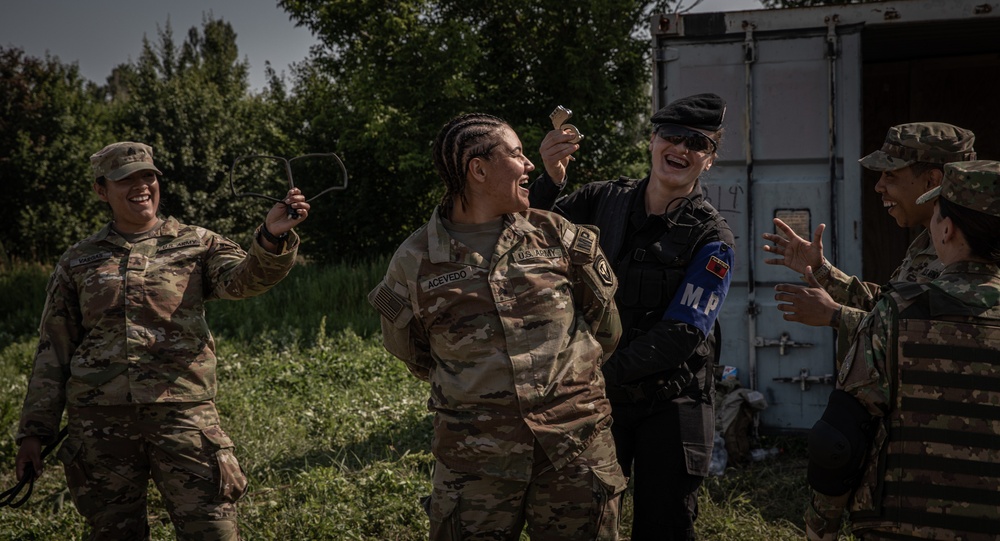 Soldiers from the 508th Military Police Company demonstrate detaining procedures to Albanian and Bulgarian servicemen during DEFENDER 23