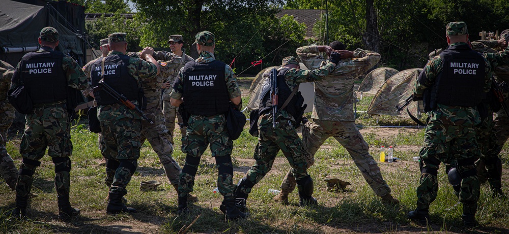 Soldiers from the 508th Military Police Company demonstrate detaining procedures to Albanian and Bulgarian servicemen during DEFENDER 23