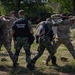 Soldiers from the 508th Military Police Company demonstrate detaining procedures to Albanian and Bulgarian servicemen during DEFENDER 23