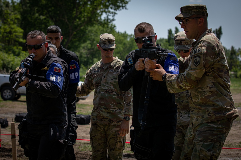 Soldiers assigned to the 508 Military Police Company display room clearing maneuvers to Albanian military police during DEFENDER 23