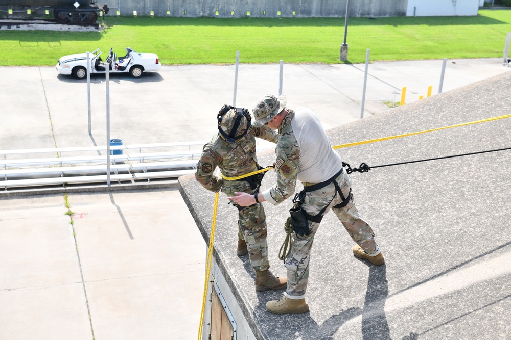 Defenders of the 147th Attack Wing practice rappelling