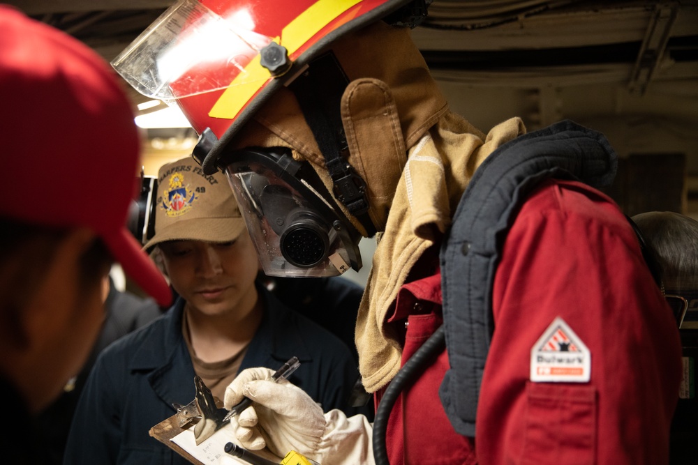 USS Harpers Ferry (LSD 49) sailors participate in a main space fire drill