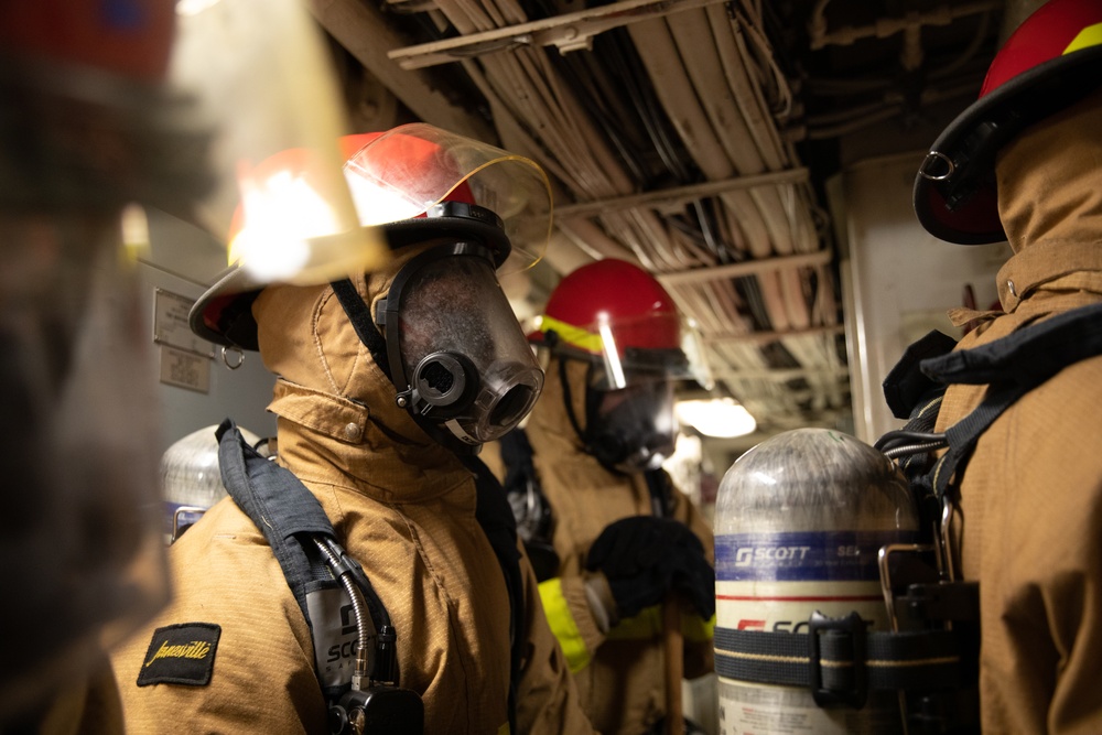 USS Harpers Ferry (LSD 49) sailors participate in a main space fire drill