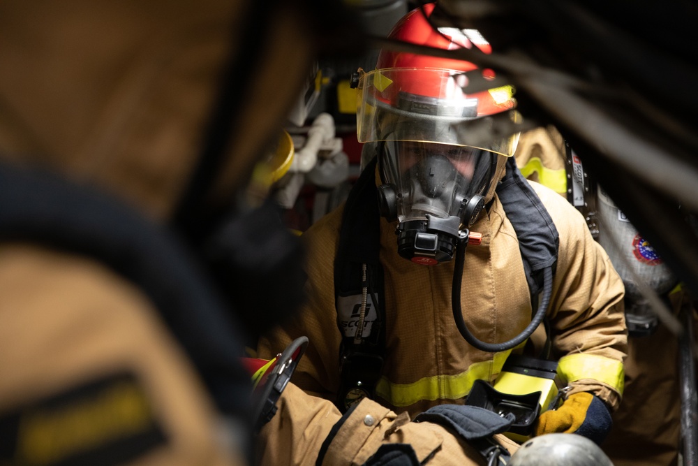 USS Harpers Ferry (LSD 49) sailors participate in a main space fire drill