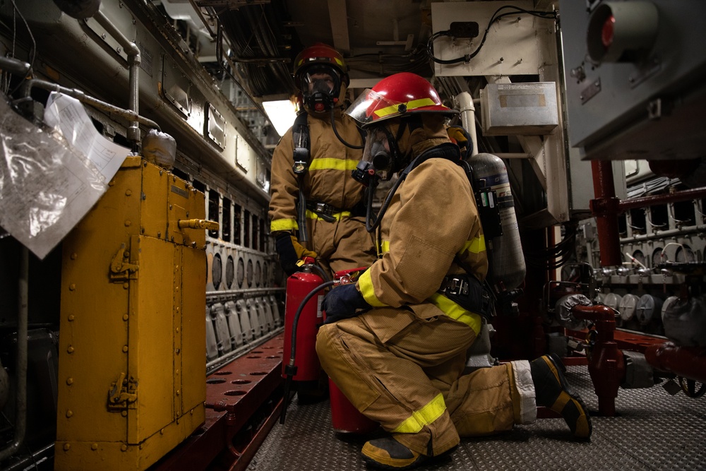 USS Harpers Ferry (LSD 49) sailors participate in a main space fire drill