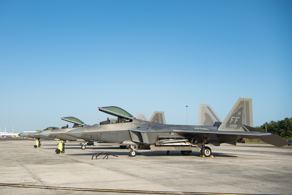 F-22 Raptors are parked on the flightline during Operation Hoodoo Sea