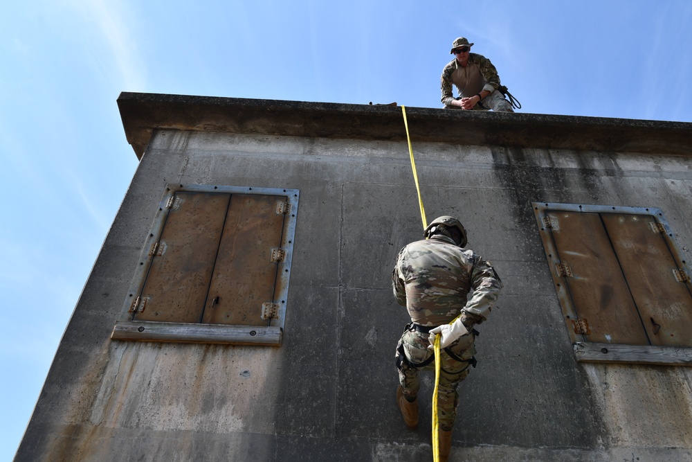 Defenders of the 147th Attack Wing practice rappelling