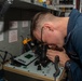 USS Ronald Reagan (CVN 76) Sailors inspect night vision goggles