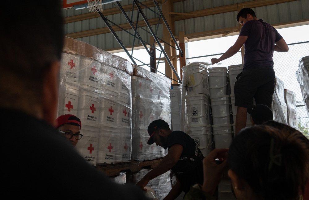 USAF, USN Volunteers prepare and distribute Typhoon Mawar disaster relief supplies