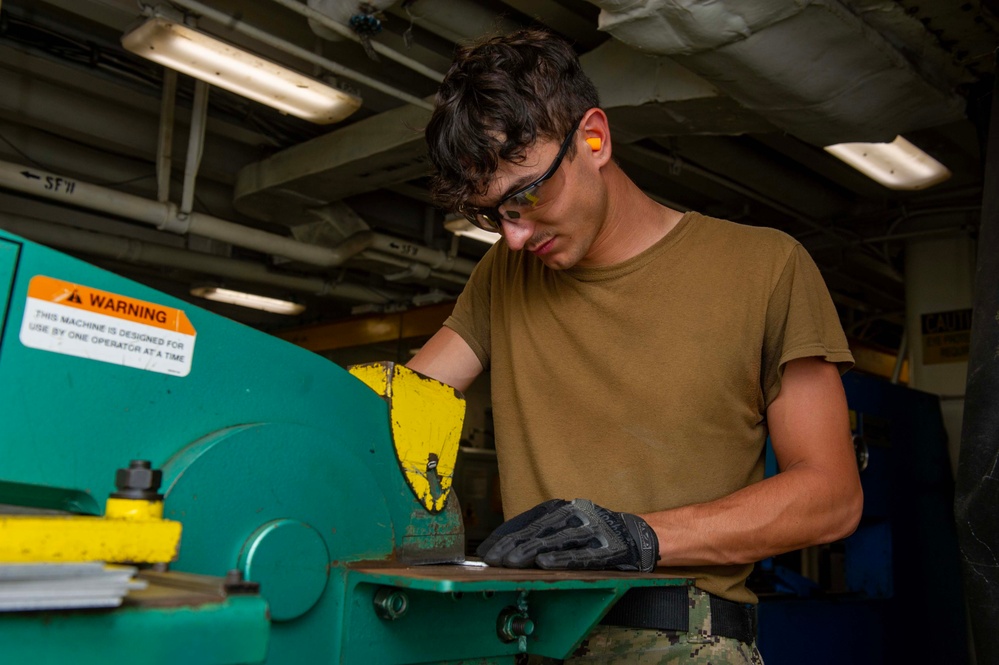 Sailor Uses a Universal Metal Worker Aboard Emory S. Land