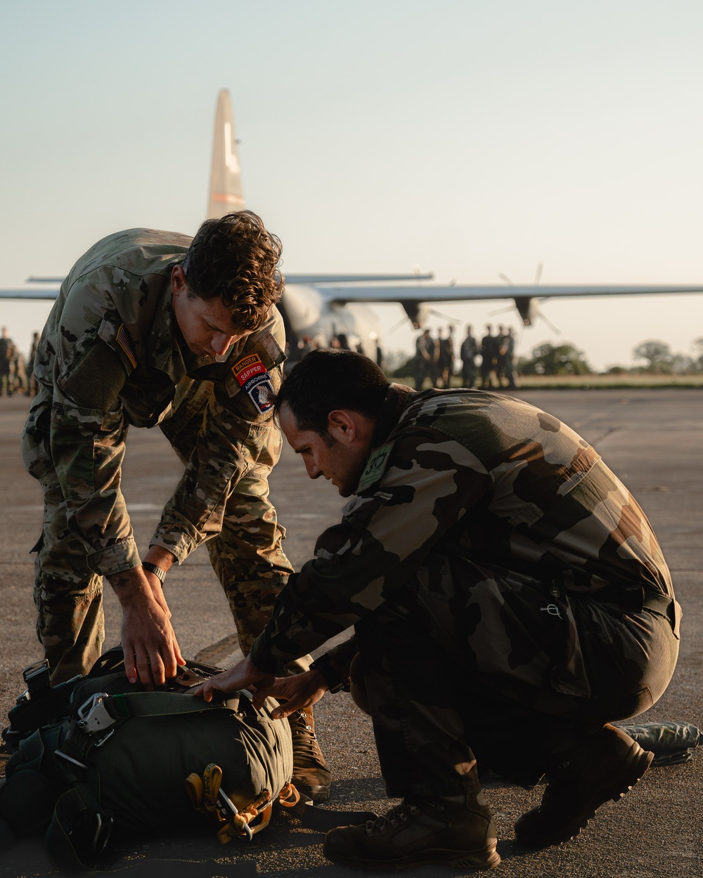 A Sky Soldier Assists French Paratrooper With His T-11 Parachute System