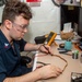 USS Ronald Reagan (CVN 76) Sailors repair components