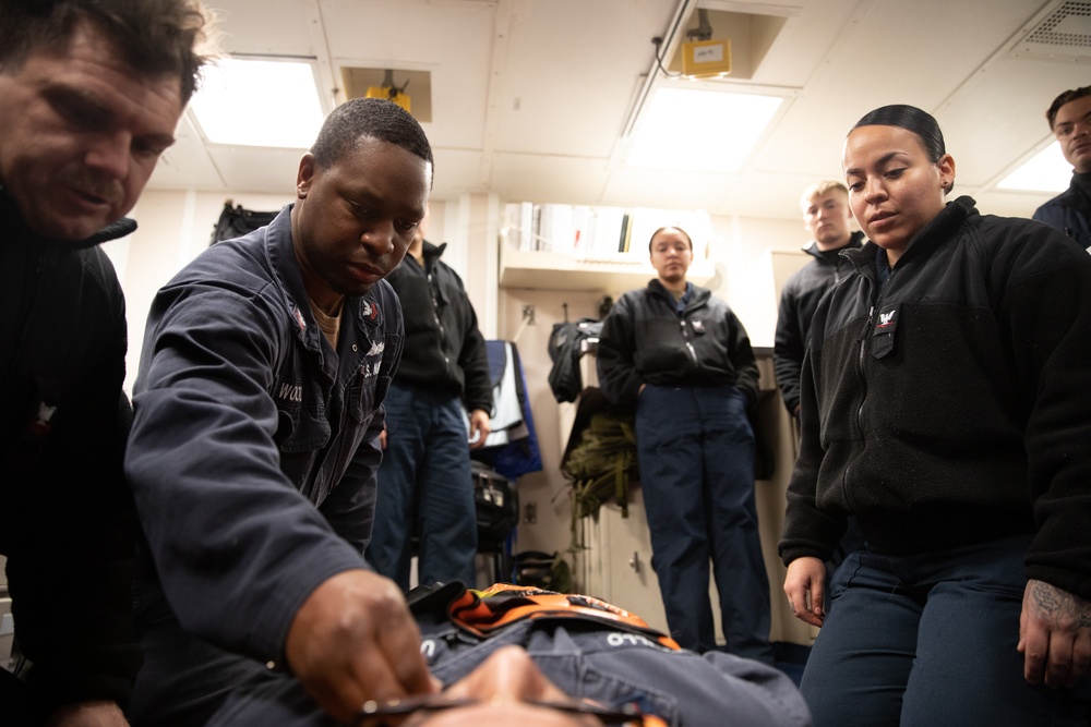 Electronic Technician 2nd Class Andre Woods assists in stretcher bearer training