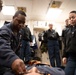 Electronic Technician 2nd Class Andre Woods assists in stretcher bearer training