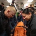 USS Harpers Ferry (LSD 49) sailors prepare to lift their shipmate in stretcher bearer training