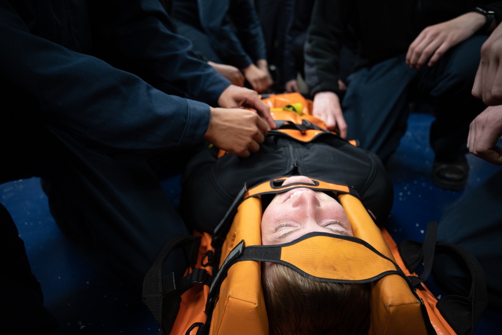 Boatswain's Mate Seaman Cale Hudson participates in stretcher bearer training