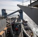 USS Harpers Ferry (LSD 49) sailors prepare to raise rigid hull inflatable boat (RHIB)
