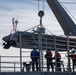 USS Harpers Ferry (LSD 49) sailors raise rigid hull inflatable boat (RHIB) from platform