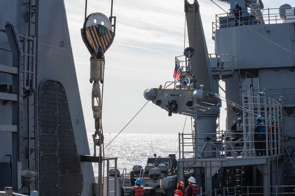 USS Harpers Ferry (LSD 49) sailors lower rigid hull inflatable boat (RHIB) into Alaskan Gulf