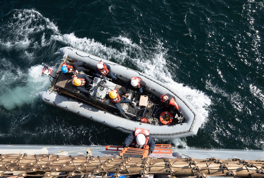 USS Harpers Ferry (LSD 49) sailors climb into rigid hull inflatable boat (RHIB)