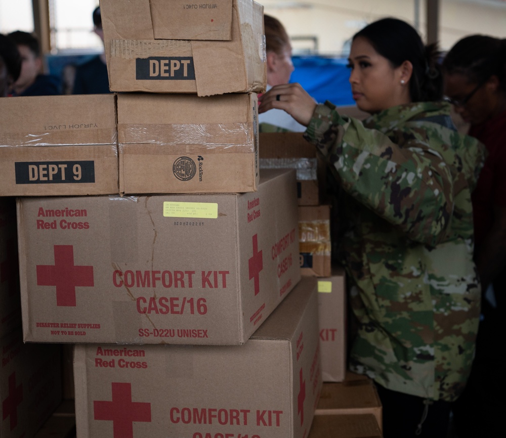 USAF, USN Volunteers prepare and distribute Typhoon Mawar disaster relief supplies