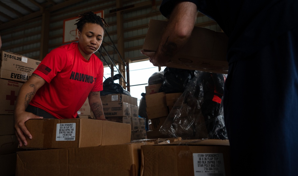 USAF, USN Volunteers prepare and distribute Typhoon Mawar disaster relief supplies