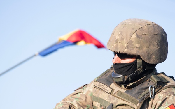 Romanian soldier prepares to travel during Saber Guardian
