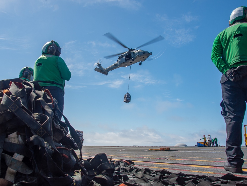 USS Ronald Reagan (CVN 76) conducts vertical replenishment (VERTREP) with USNS Wally Schirra