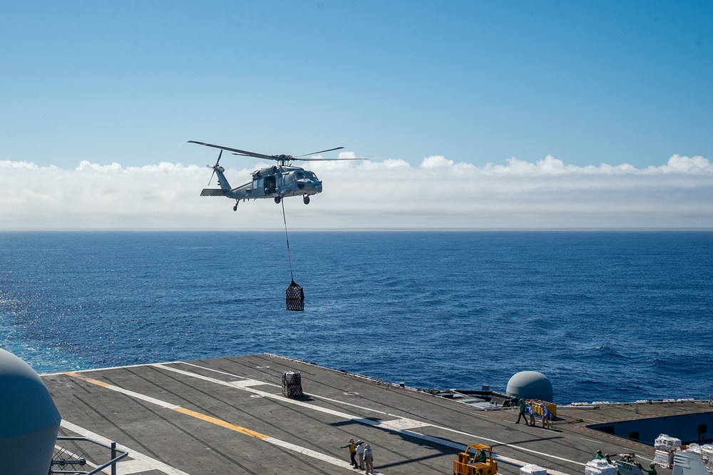 USS Ronald Reagan (CVN 76) conducts vertical replenishment (VERTREP) with USNS Wally Schirra