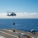 USS Ronald Reagan (CVN 76) conducts vertical replenishment (VERTREP) with USNS Wally Schirra