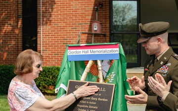 Mrs. Betty Gordon and LTC Trent Colestock unveil the plaque for Gordon Hall.