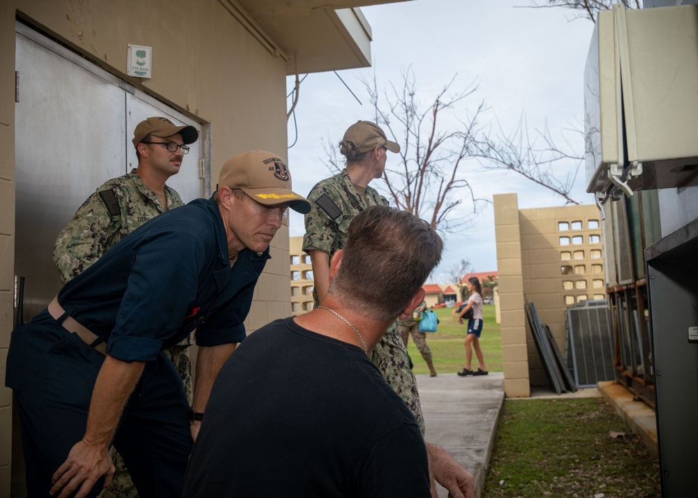 ESl Sailors Assess AC Unit on Anderson AFB