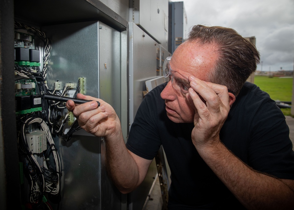 ESl Sailors Assess AC Unit on Anderson AFB