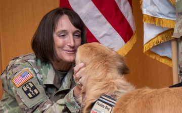 Newly pinned Air Force major accepts his duty with nose bop, paw salute