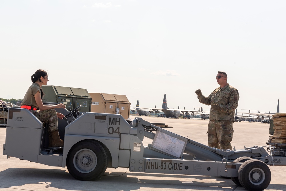 U.S. Airmen work together near the flight Line at exercise Air Defender 2023