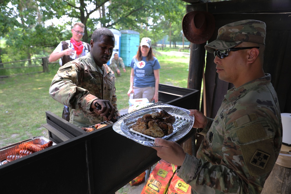 4th Infantry Division Soldiers participate in a cookout with students at an English language school in Boleslawiec, Poland