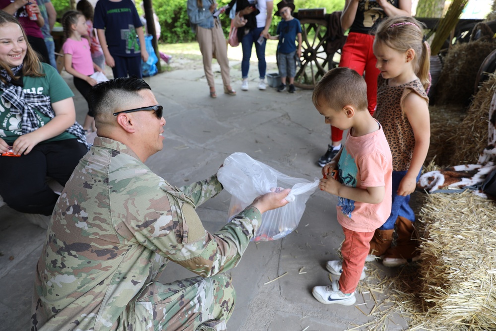 4th Infantry Division Soldiers participate in a cookout with students at an English language school in Boleslawiec, Poland