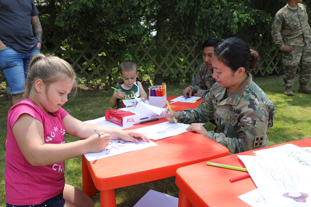 4th Infantry Division Soldiers participate in a cookout with students at an English language school in Boleslawiec, Poland