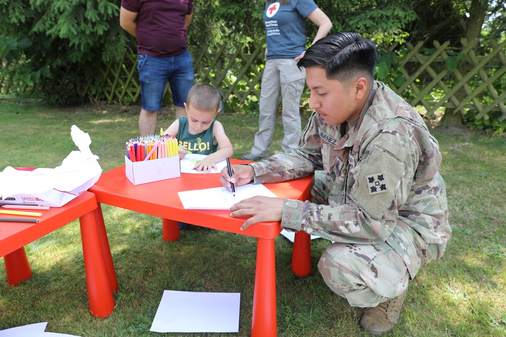 4th Infantry Division Soldiers participate in a cookout with students at an English language school in Boleslawiec, Poland